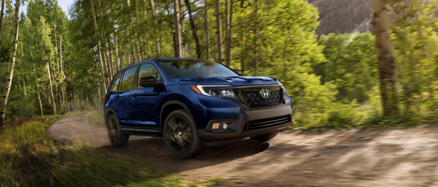 2020 Honda Passport driving by trees