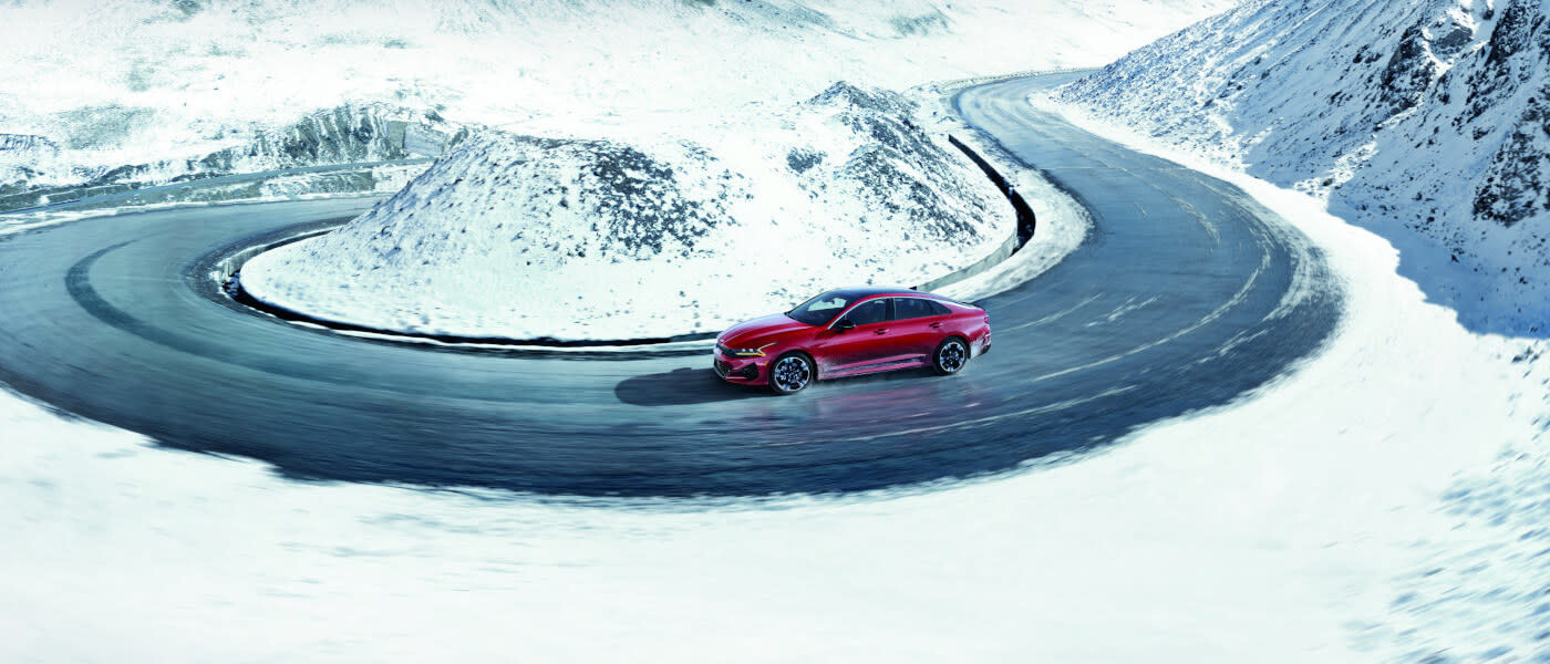 2024 Kia Forte driving on snowy mountain road