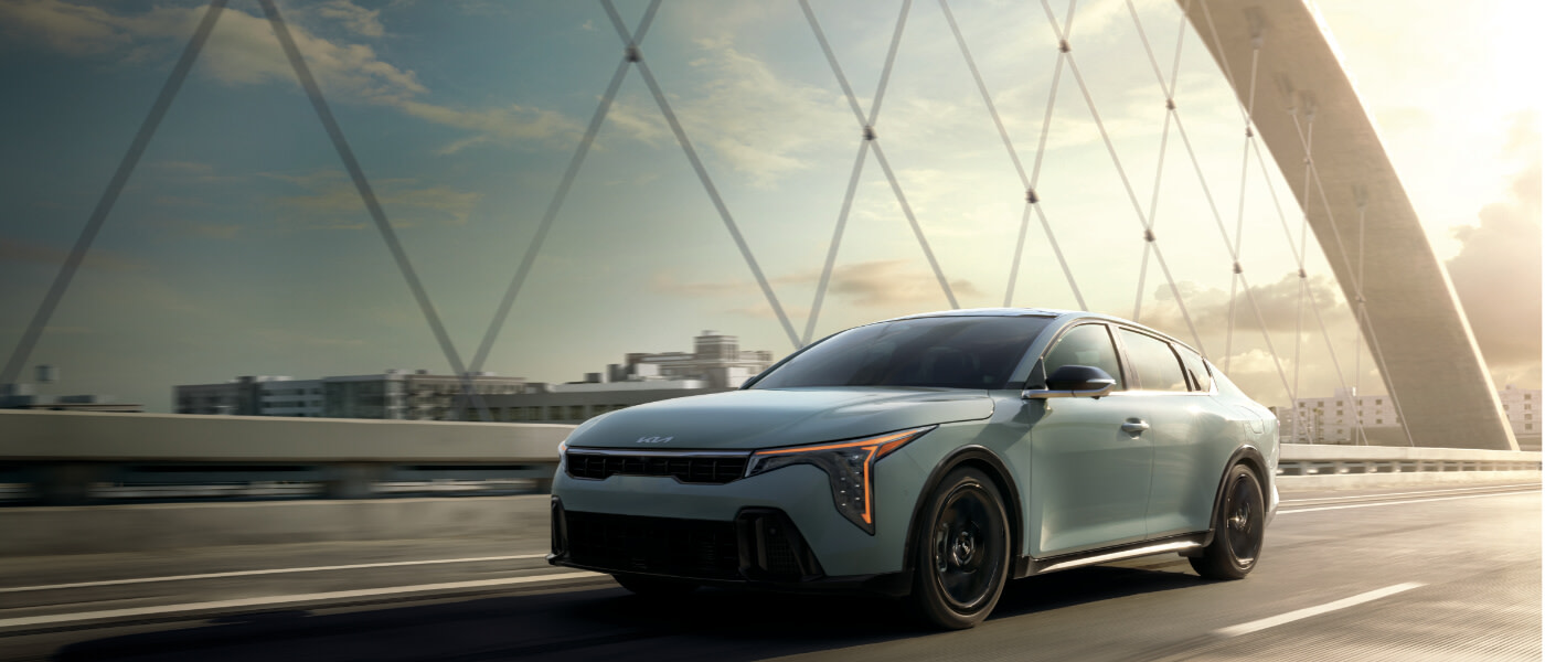 2025 Kia K4 driving on a bridge