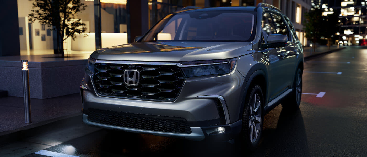 2025 Honda Pilot parked on city street at night