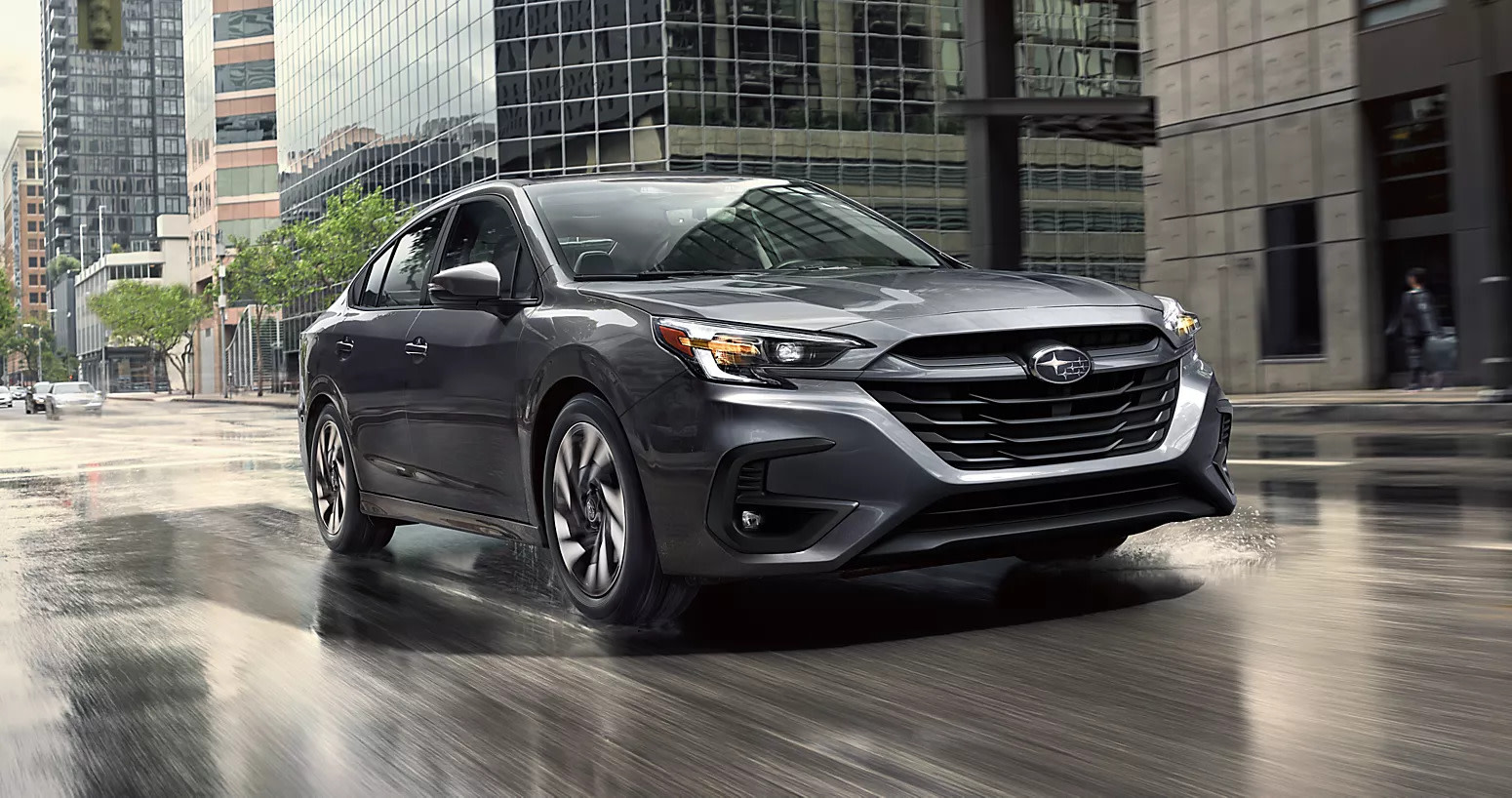 front view of a grey 2025 subaru legacy driving in the city