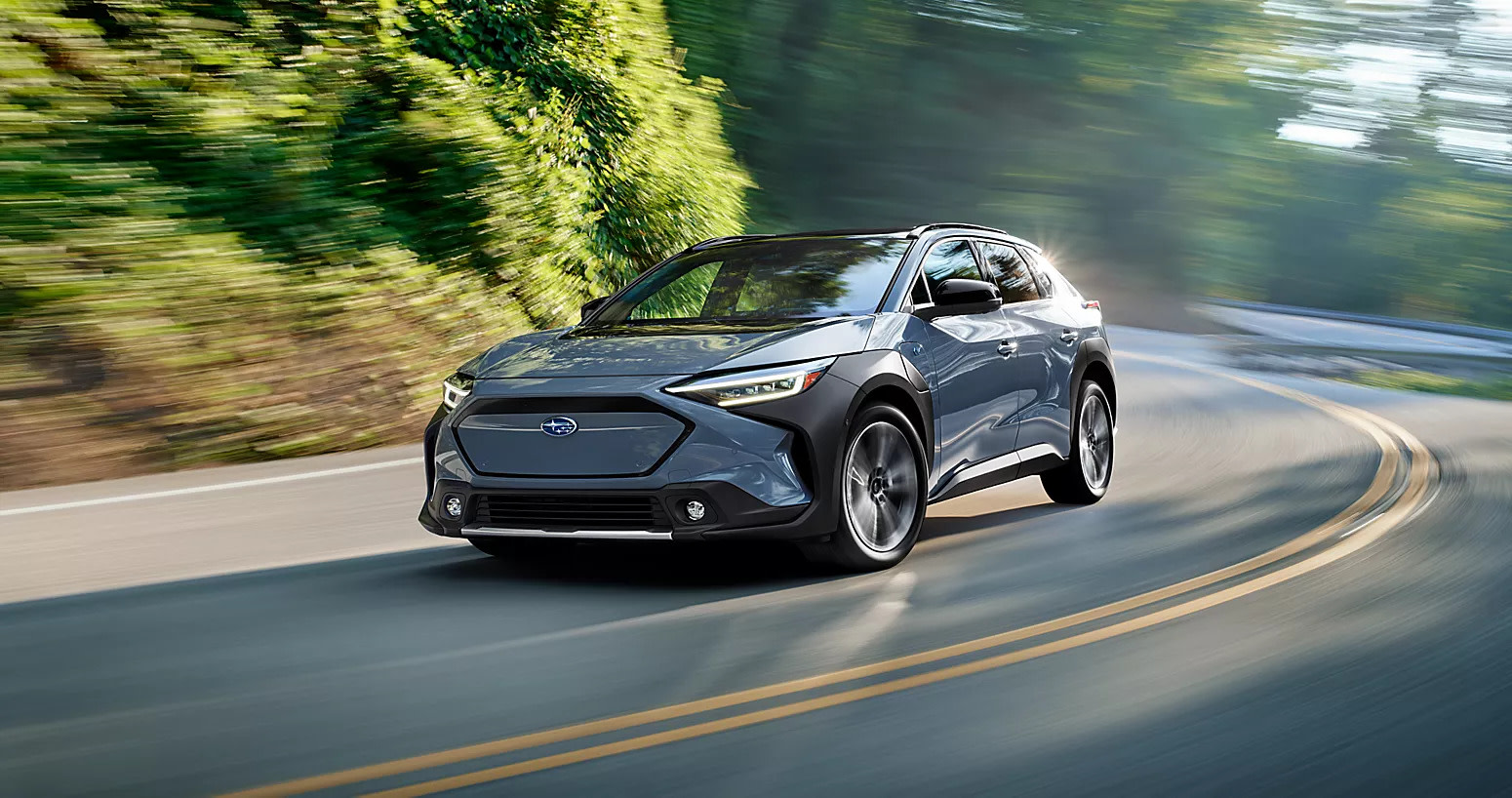 a 2025 subaru solterra driving on a winding road