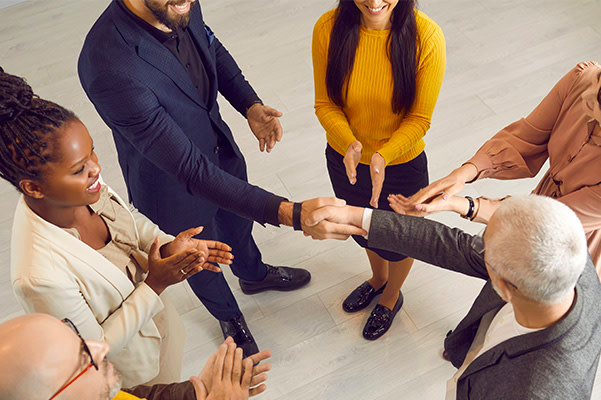 Employees shaking hands and meeting with one another.