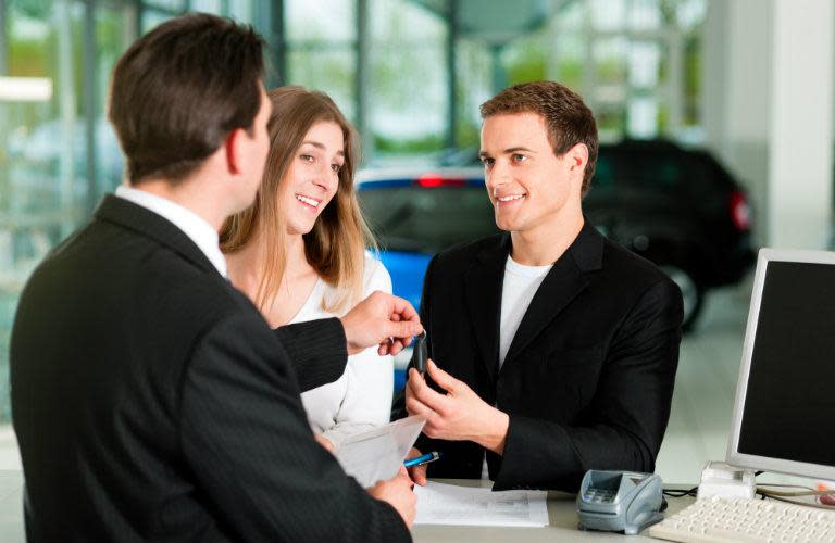 couple at table in car dealership