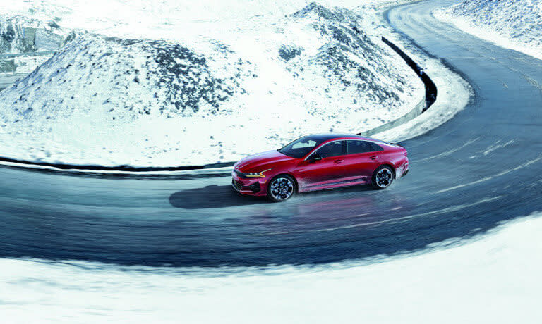 2024 Kia Forte driving in the snowy mountains