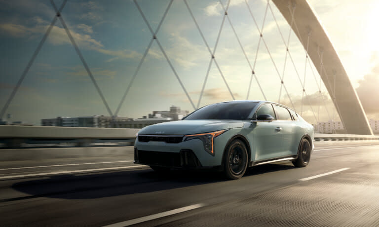 2025 Kia K4 driving on a bridge