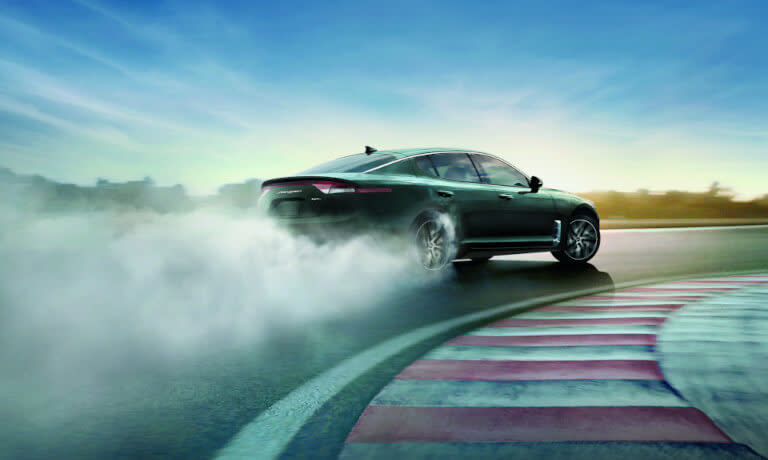 2024 Kia Forte on racetrack with smoking tires