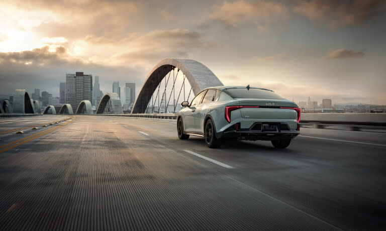 2025 Kia K4 driving away on a bridge