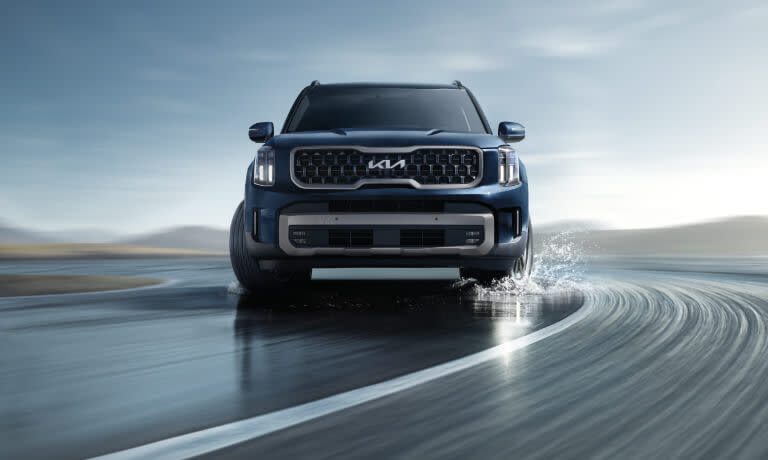 2025 Kia Telluride driving on a wet road
