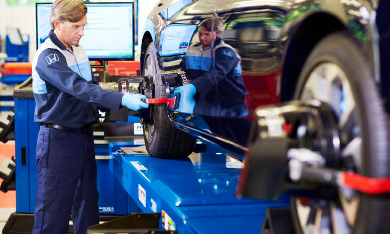 Honda Service Mechanic Checking Wheel