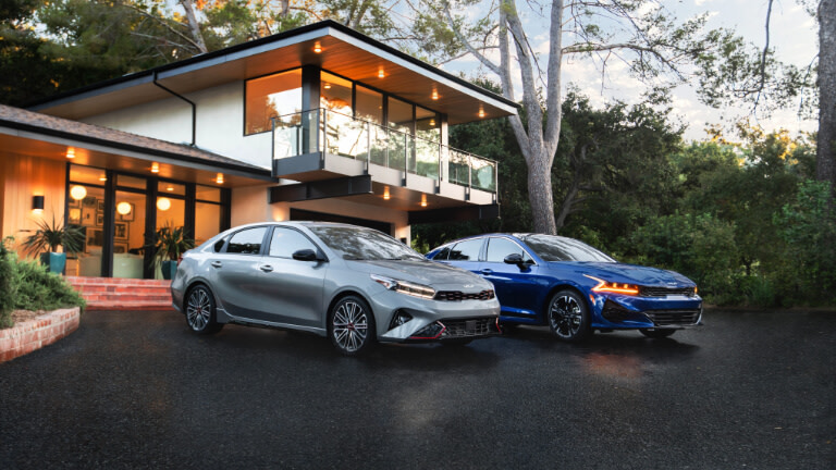 2025 Kia K5 pair parked outside house