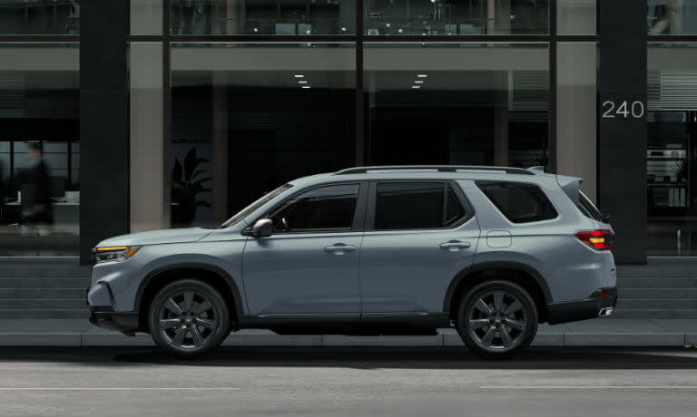2025 Honda Pilot side view parked outside building